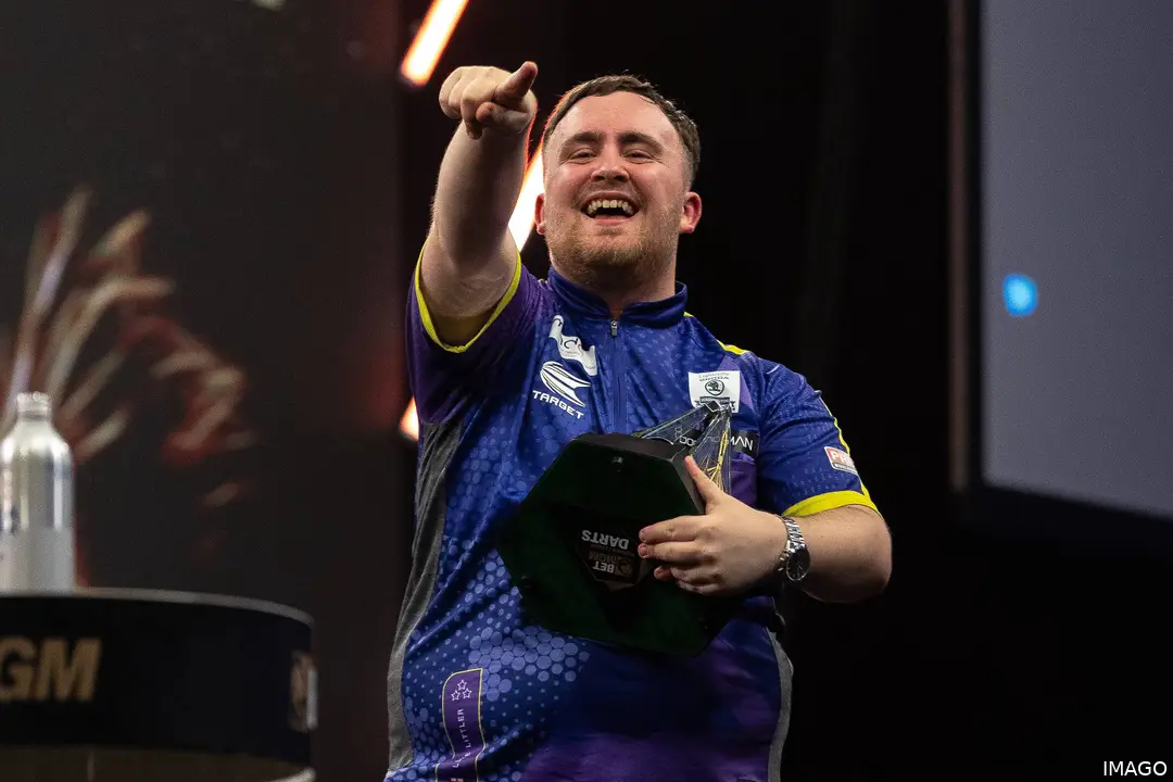 Luke Littler celebrates with the Premier League trophy
