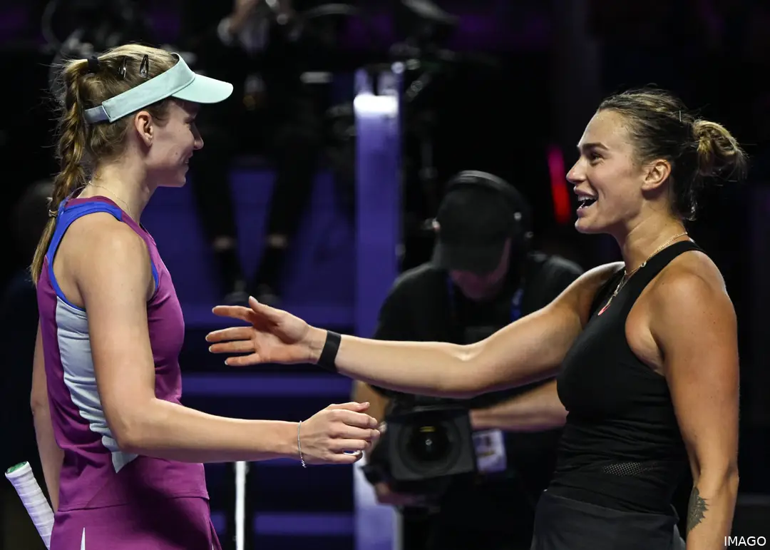 Aryna Sabalenka and Elena Rybakina embracing at the net in the WTA Finals