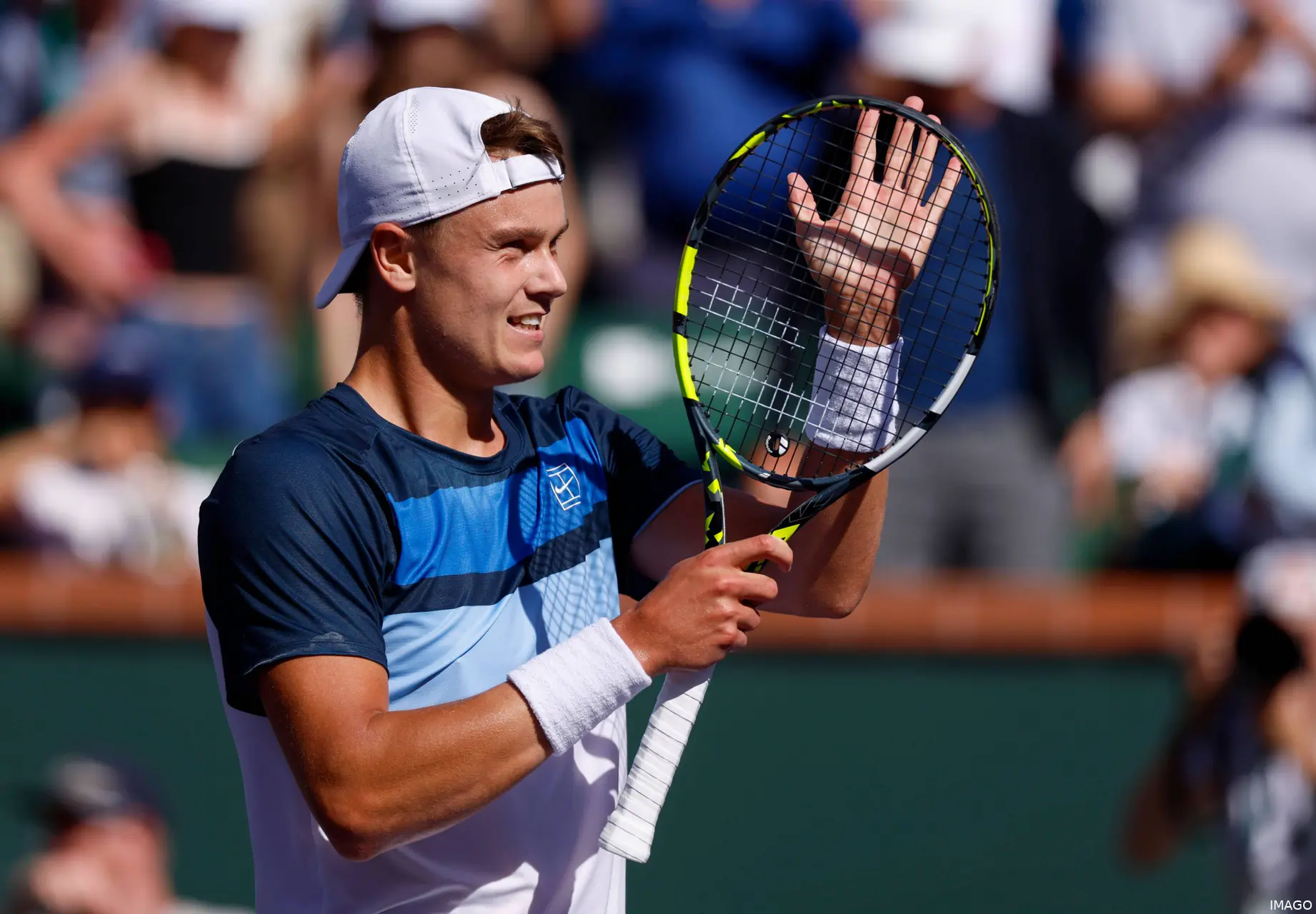 Holger Rune smiles as he applauds the Indian Wells crowd