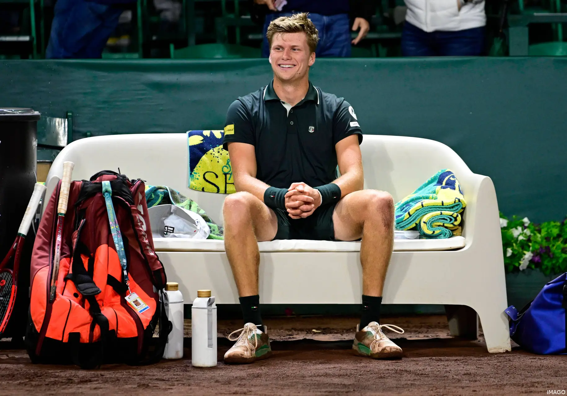 Jenson Brooksby sitting on the bench after winning the Houston Open title against Tiafoe
