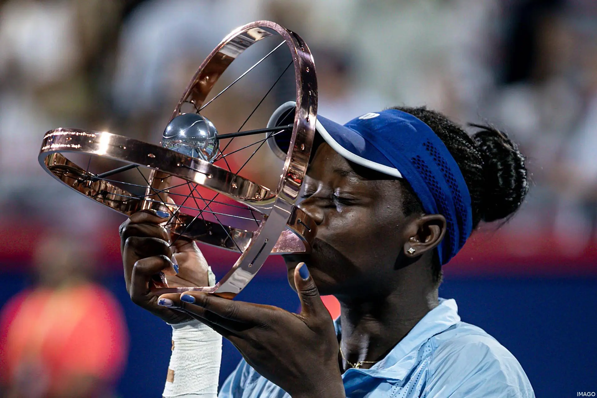 Victoria Mboko kisses the Canadian Open trophy in 2025 after her triumphant run