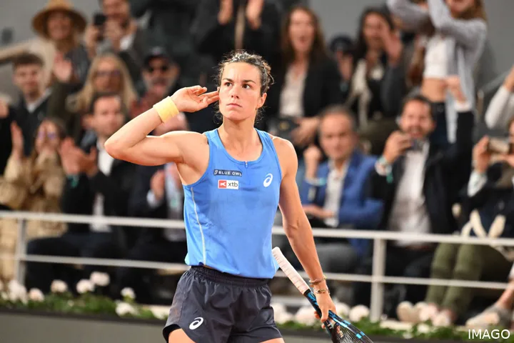 Boisson touches her ear and looks at the crowd after the Roland Garros quarter-final victory