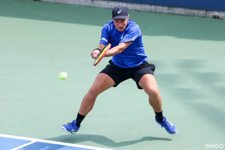Kamil Majchrzak on court hitting the ball