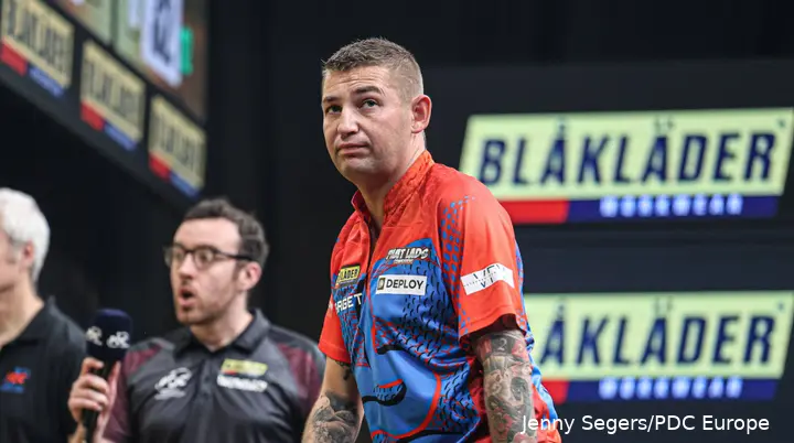 Nathan Aspinall looks on.