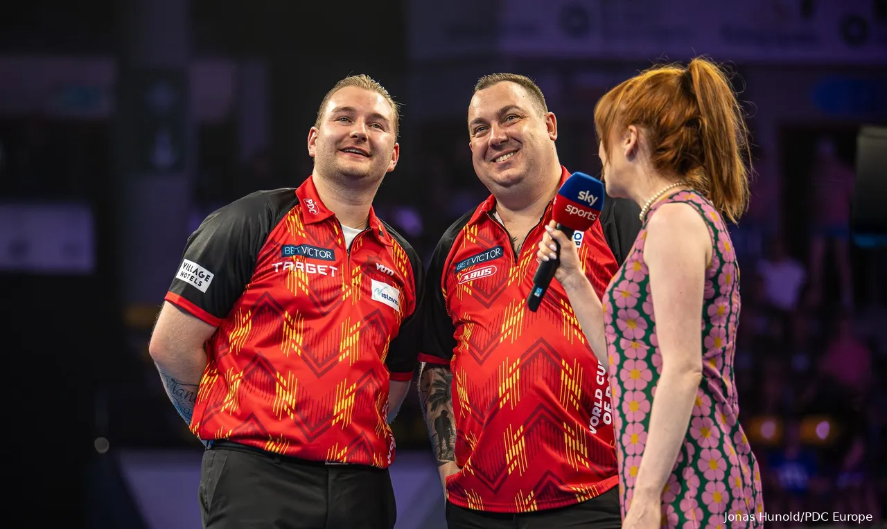 Dimitri Van den Bergh and Kim Huybrechts on the stage of the World Cup of Darts