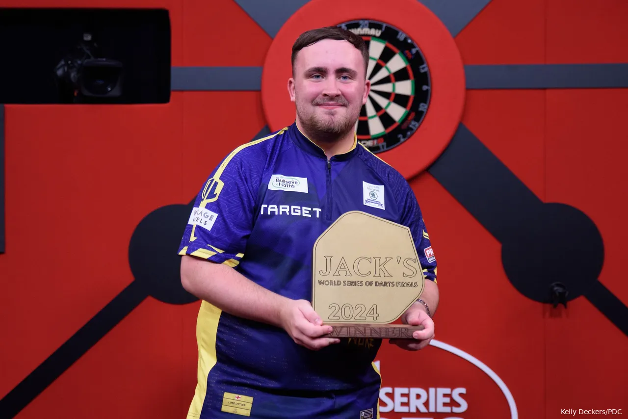 Luke Littler with his trophy from the World Series of Darts Finals