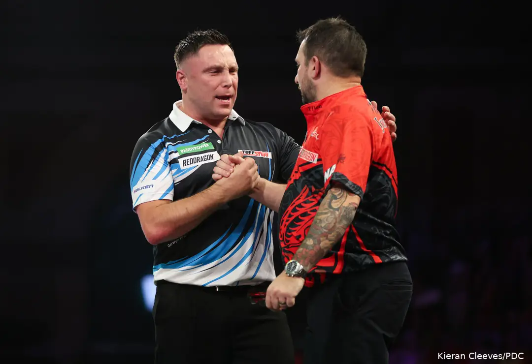 Gerwyn Price and Jonny Clayton shake hands on stage.