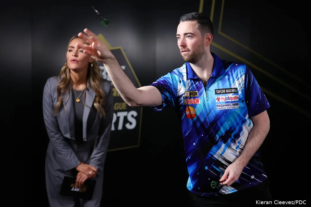 Luke Humphries takes on BetMGM's Eye of the Needle challenge as presenter Laura Woods watches on