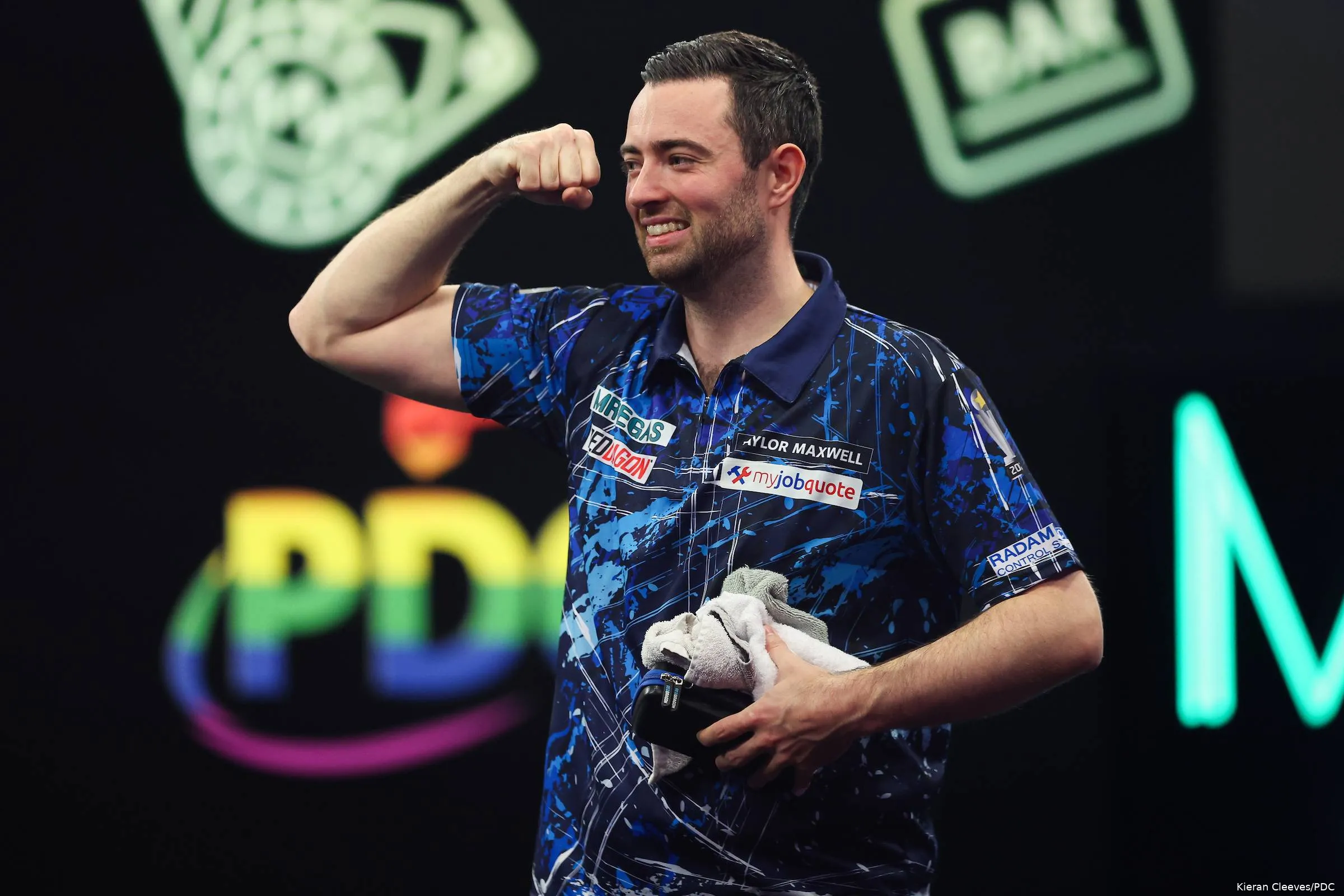 Luke Humphries clenches his fist after winning Grand Slam opener.