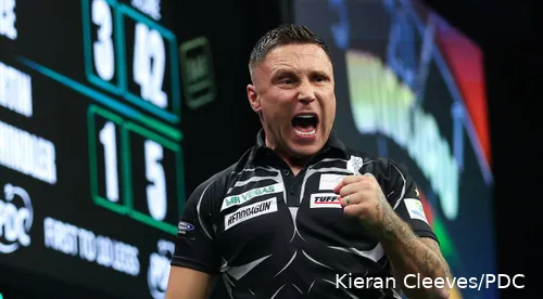Gerwyn Price has mouth open and fist clenched letting out a roar against Martin Schindler.