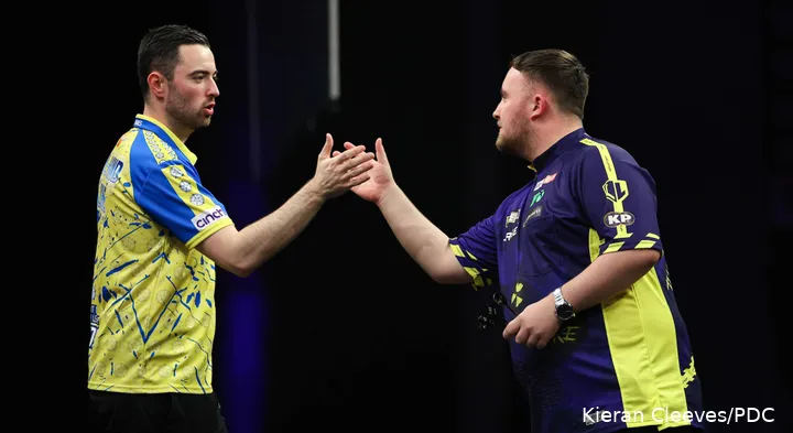 Luke Humphries and Luke Littler in action during the Premier League Darts