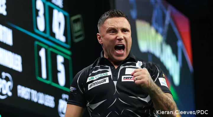 Gerwyn Price has mouth open and fist clenched letting out a roar against Martin Schindler.