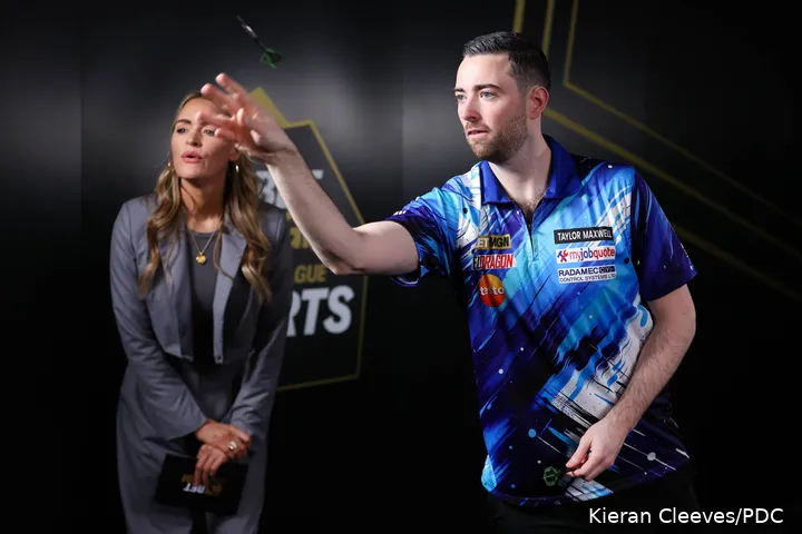 Luke Humphries takes on BetMGM's Eye of the Needle challenge as presenter Laura Woods watches on