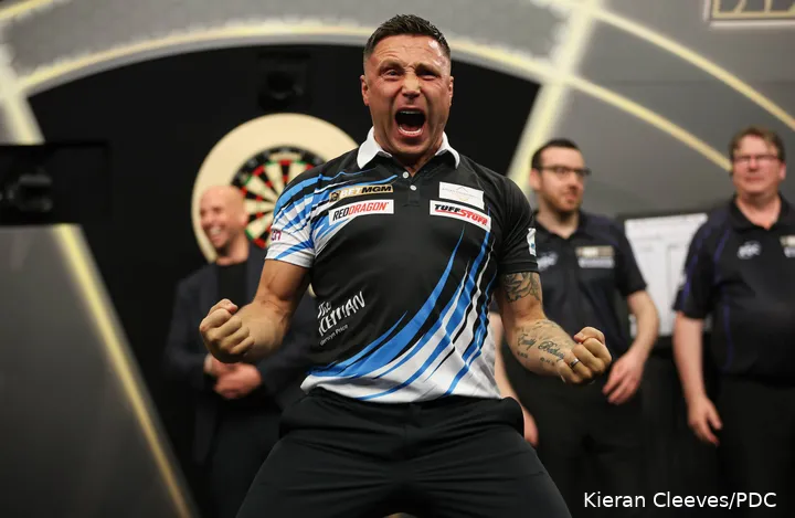 Gerwyn Price passionately celebrating on the Premier League Darts stage
