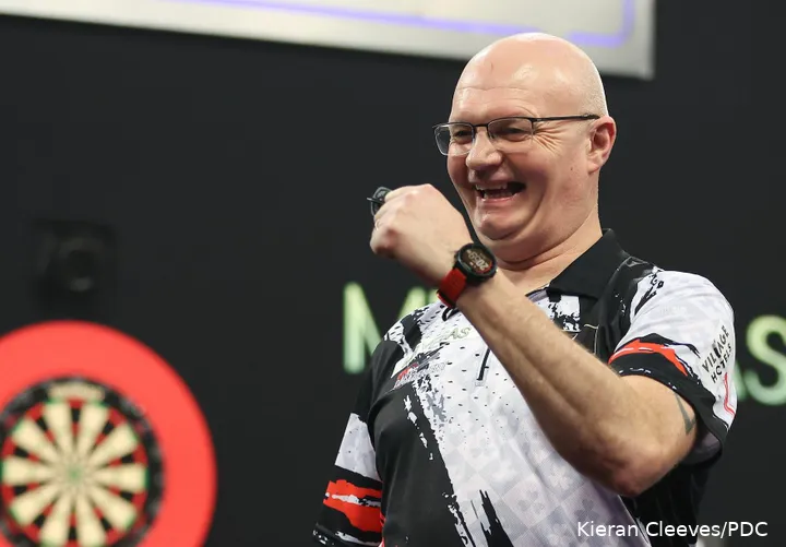 Mickey Mansell pumps his fist and smiles at the crowd.