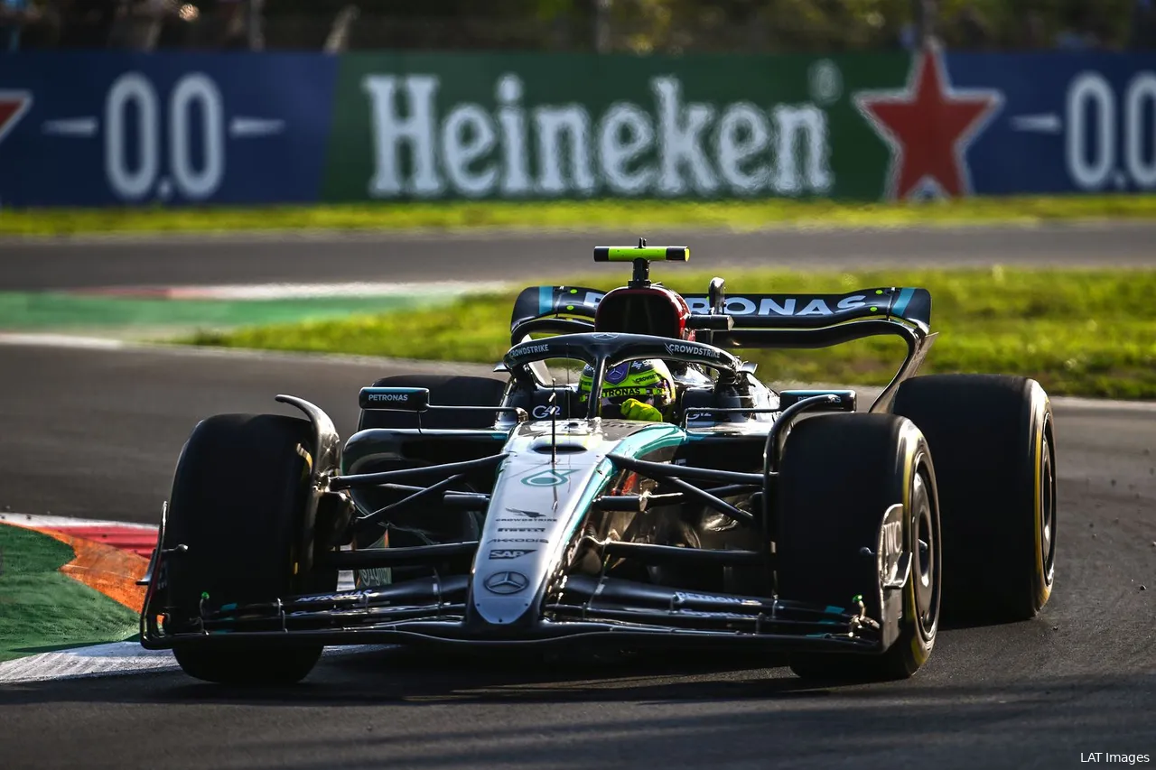 Lewis Hamilton turning right at the exit of the 'Della Roggia' chicane at Monza, with earlier corners in the background.