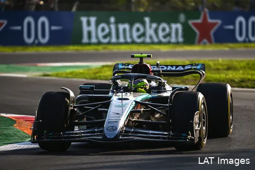 Lewis Hamilton turning right at the exit of the 'Della Roggia' chicane at Monza, with earlier corners in the background.