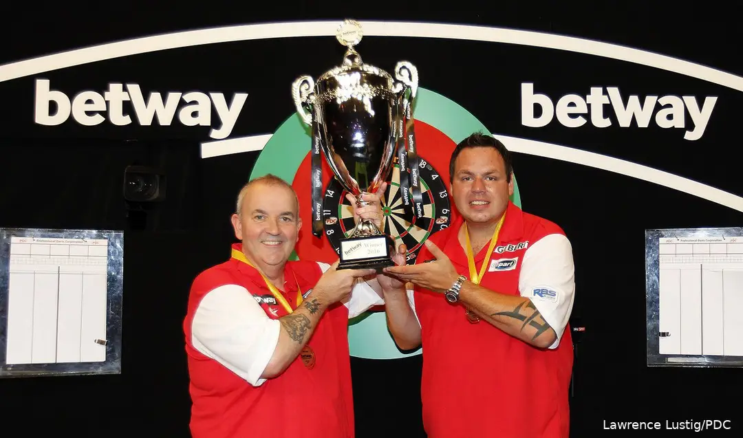 Phil Taylor and Adrian Lewis hold the World Cup trophy