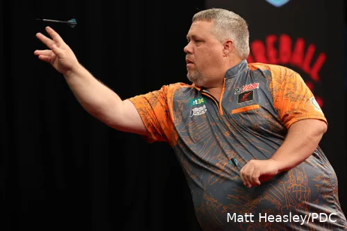 jason brandon throwing a dart on stage