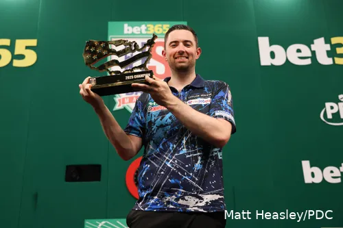 Luke Humphries holds the trophy he received after winning the US Darts Masters
