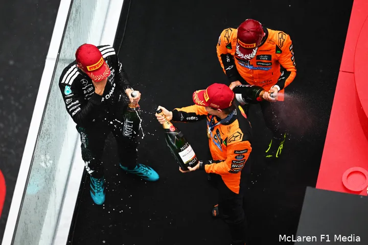 champagne podium george russell lando norris oscar piastri