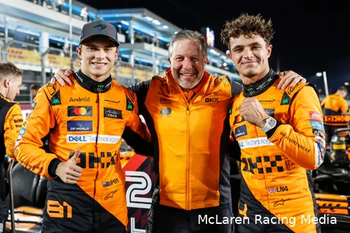 Oscar Piastri, Zak Brown, and Lando Norris pose together, smiling for the cameras after McLaren's one-two finish in the 2024 Qatar sprint race.