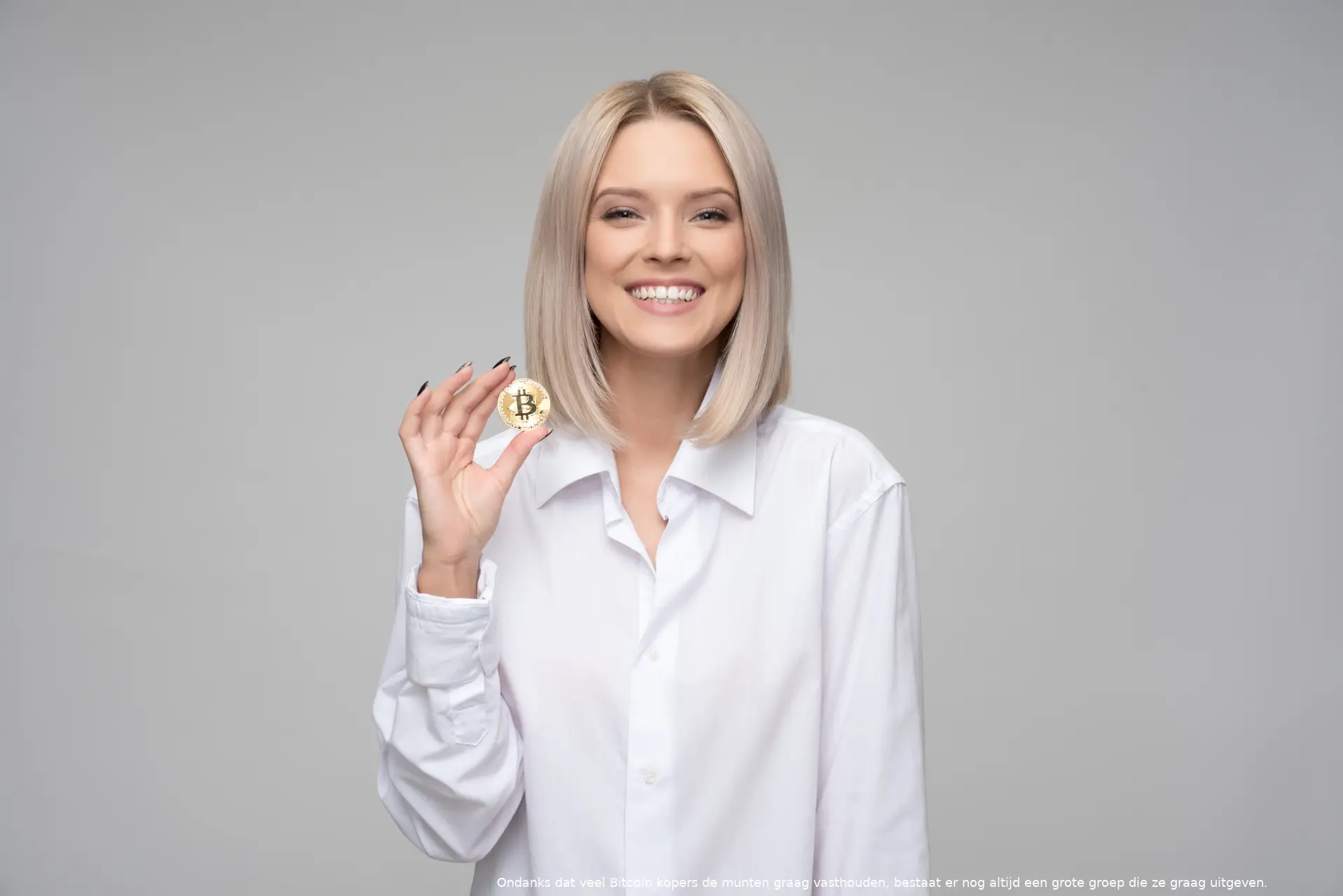 canva women wearing white long sleeved collared shirt holding bitcoin