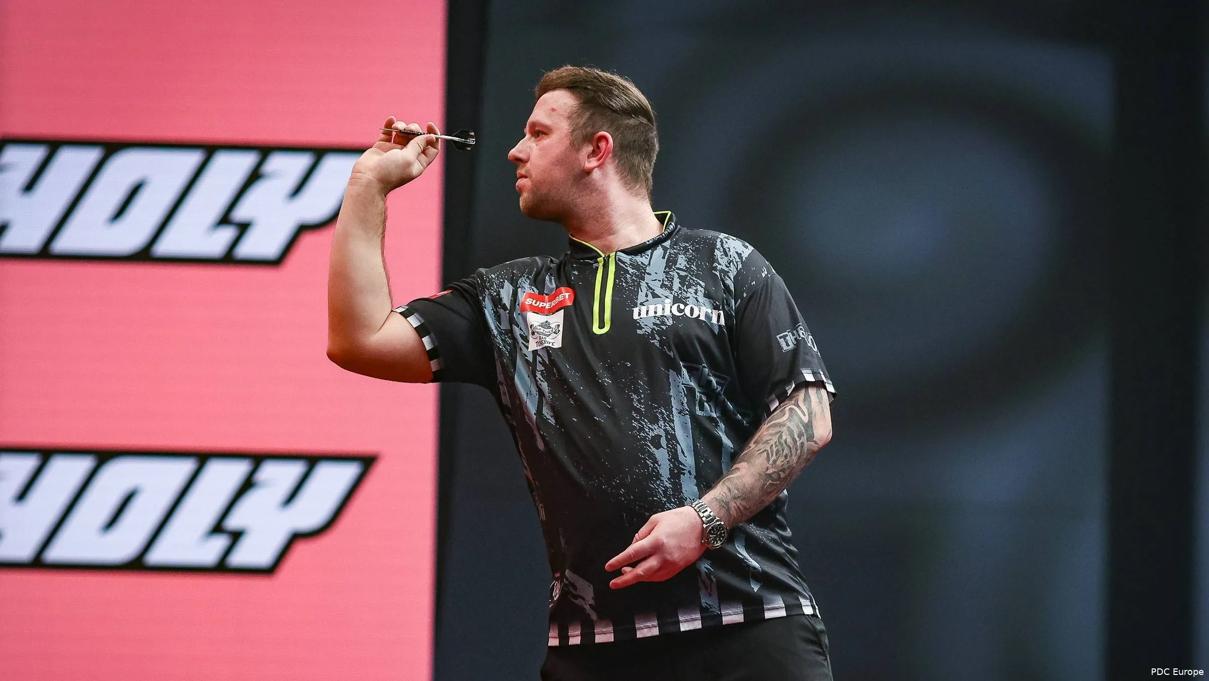 Callan Rydz throws a dart.