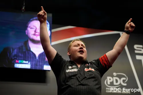 Martin Schindler as overall winner on the podium in Basel during the Swiss Darts Trophy