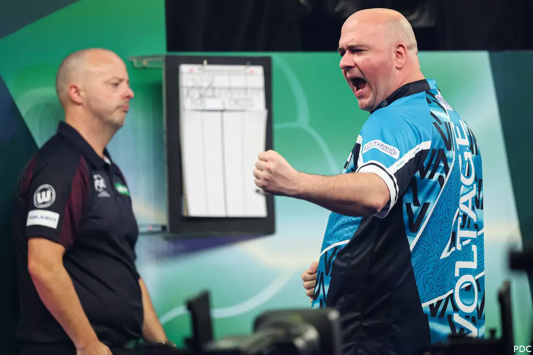 Rob Cross celebrates winning a leg