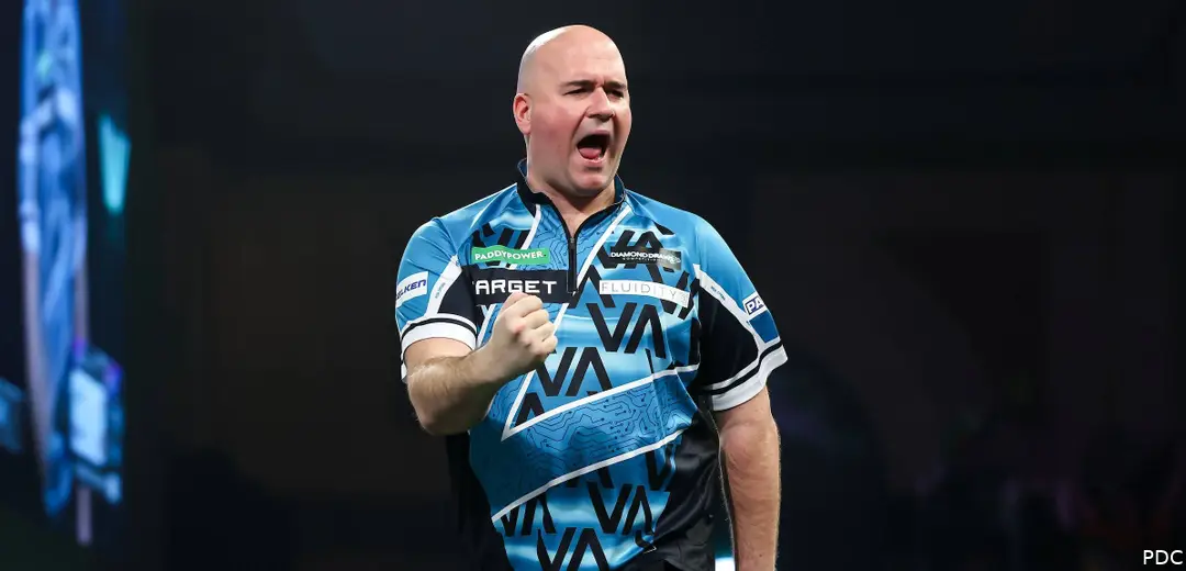 Rob Cross clenches fist on stage with mouth open.