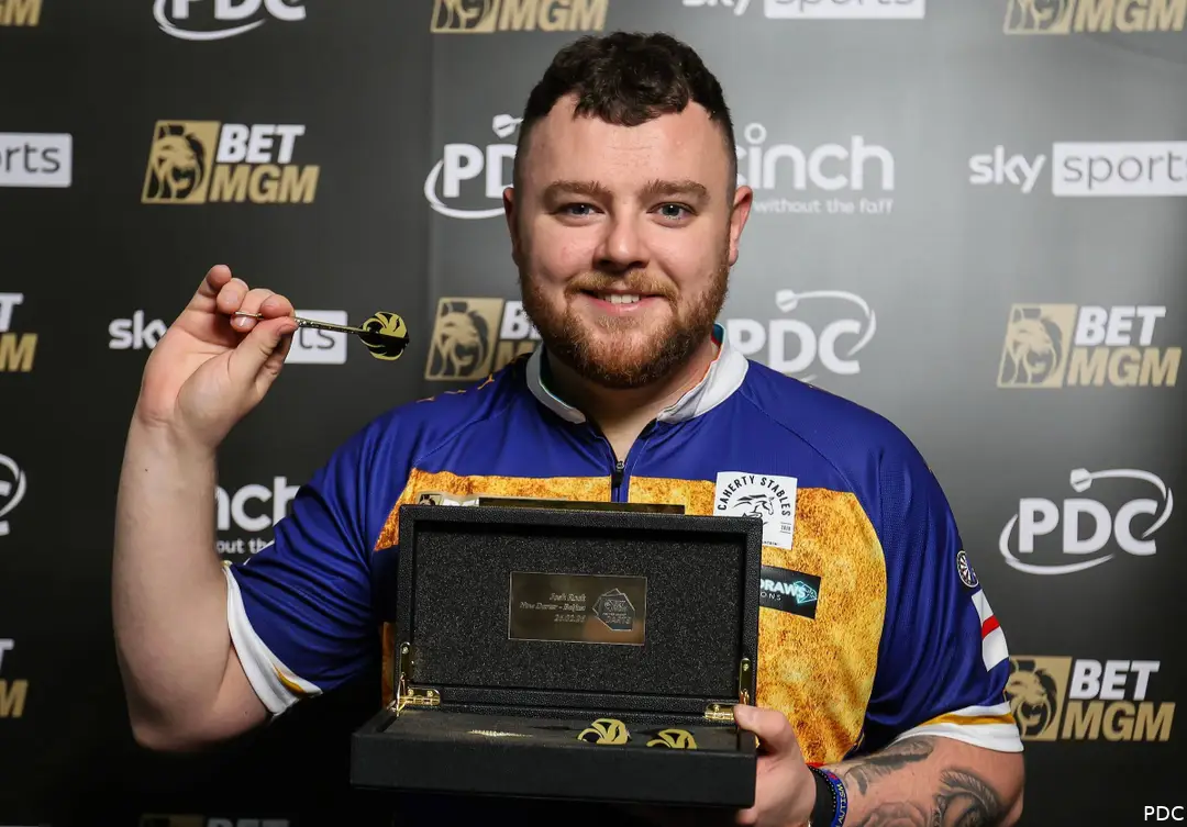 Josh Rock receives his gold darts for hitting a Premier League Darts nine-darter
