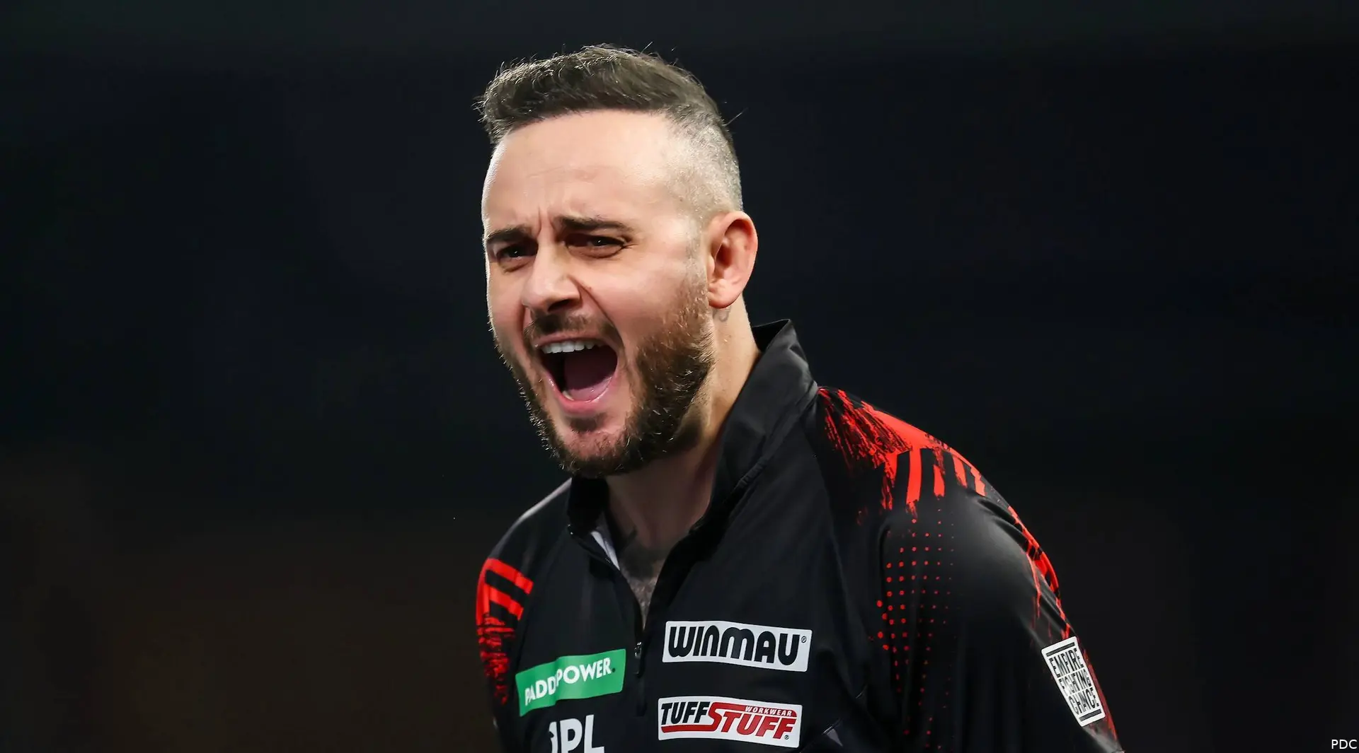 Joe Cullen screams on stage.