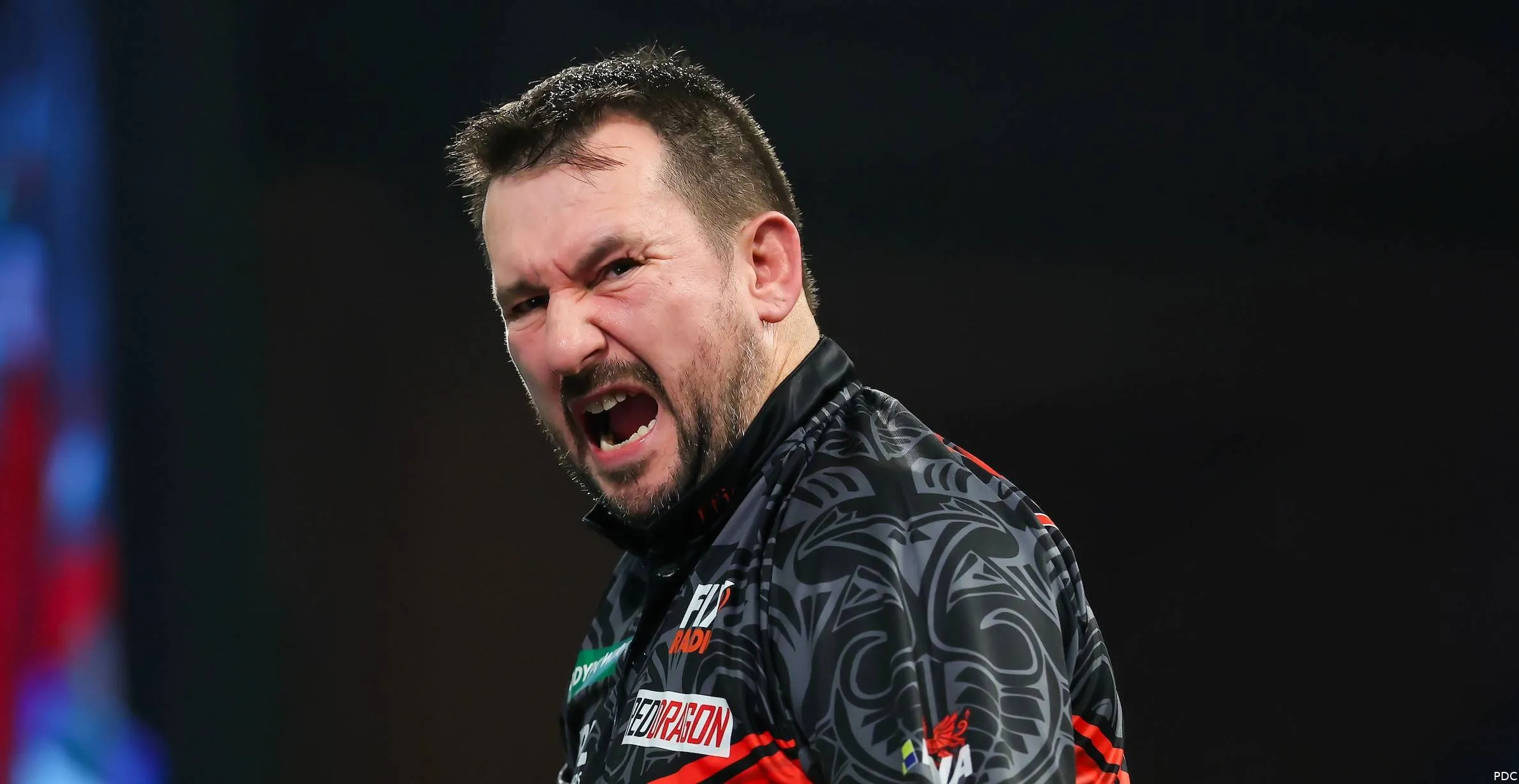 Jonny Clayton celebrates with mouth wide open.