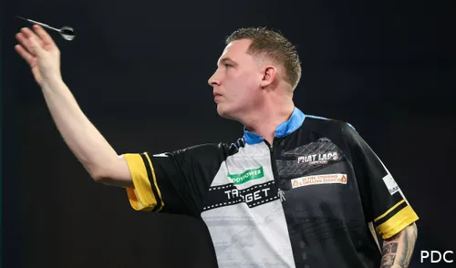 Chris Dobey throws his darts at the board.