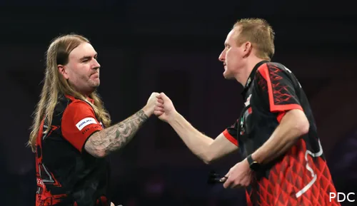 Ryan Searle shakes hands with Chris Landman on stage.