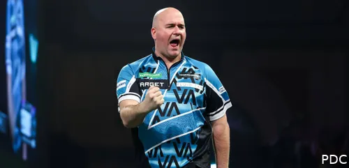Rob Cross clenches fist on stage with mouth open.
