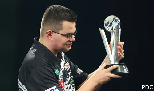 Gian van Veen poses with his runner-up trophy from the recent PDC World Darts Championship
