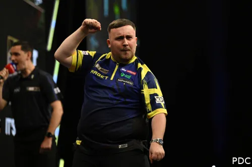 Luke Littler pumps his fist toward the crowd.