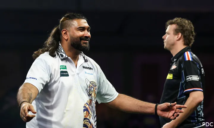 Nitin Kumar celebrates his 180 shaking his arms.