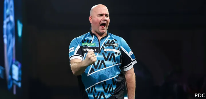 Rob Cross clenches fist on stage with mouth open.