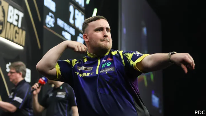 Luke Littler celebrates on stage
