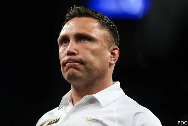 Gerwyn Price looks on.