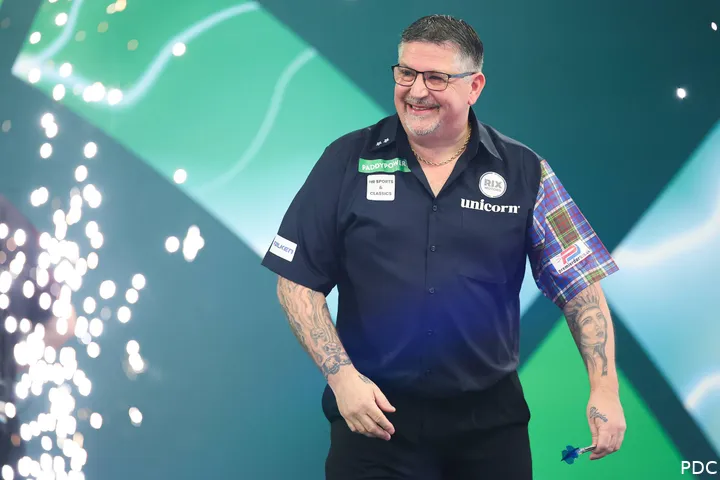 Gary Anderson loopt lachend van het podium af