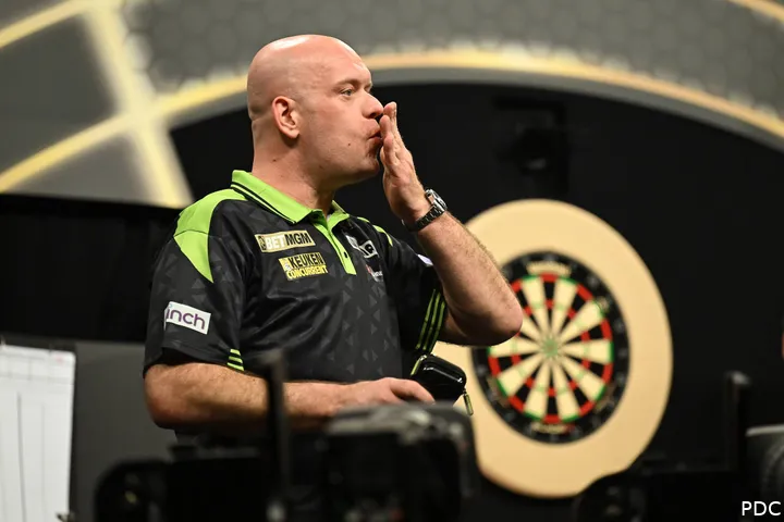 Michael van Gerwen maakt een kusgebaar met zijn hand.
