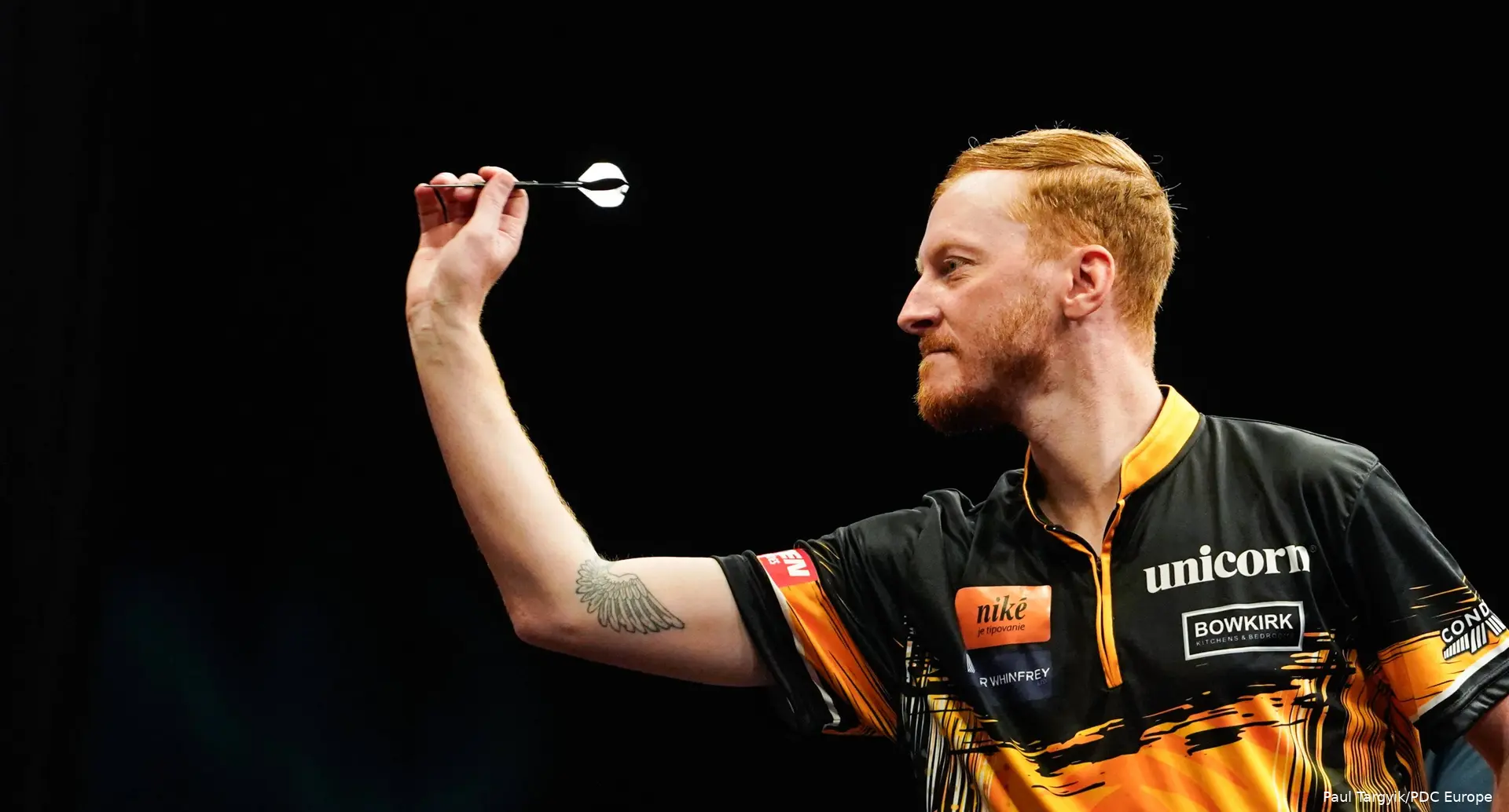 Tom Sykes throws dart.