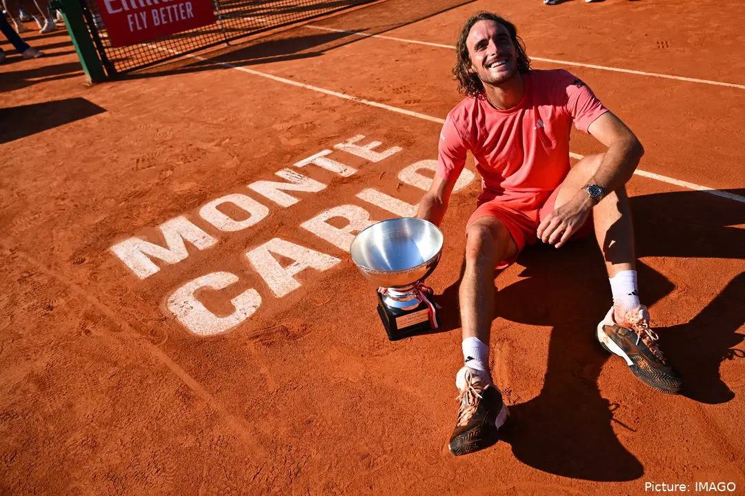 Stefanos Tsitsipas sitting on the court next to his trophy, after winning the Monte Carlo Masters