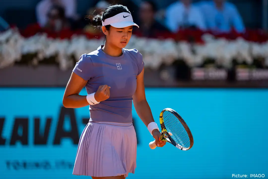 Alexandra Eala fist bumps.