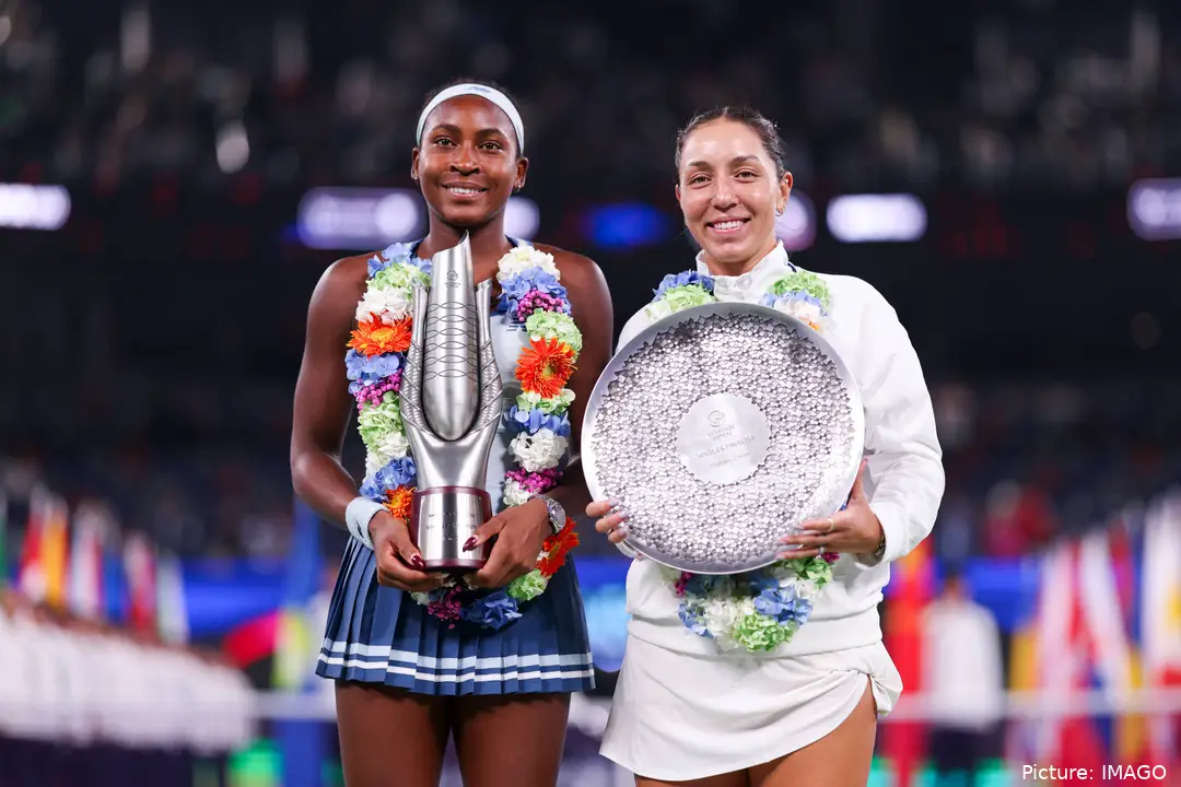 Coco Gauff and Jessica Pegula holding trophies