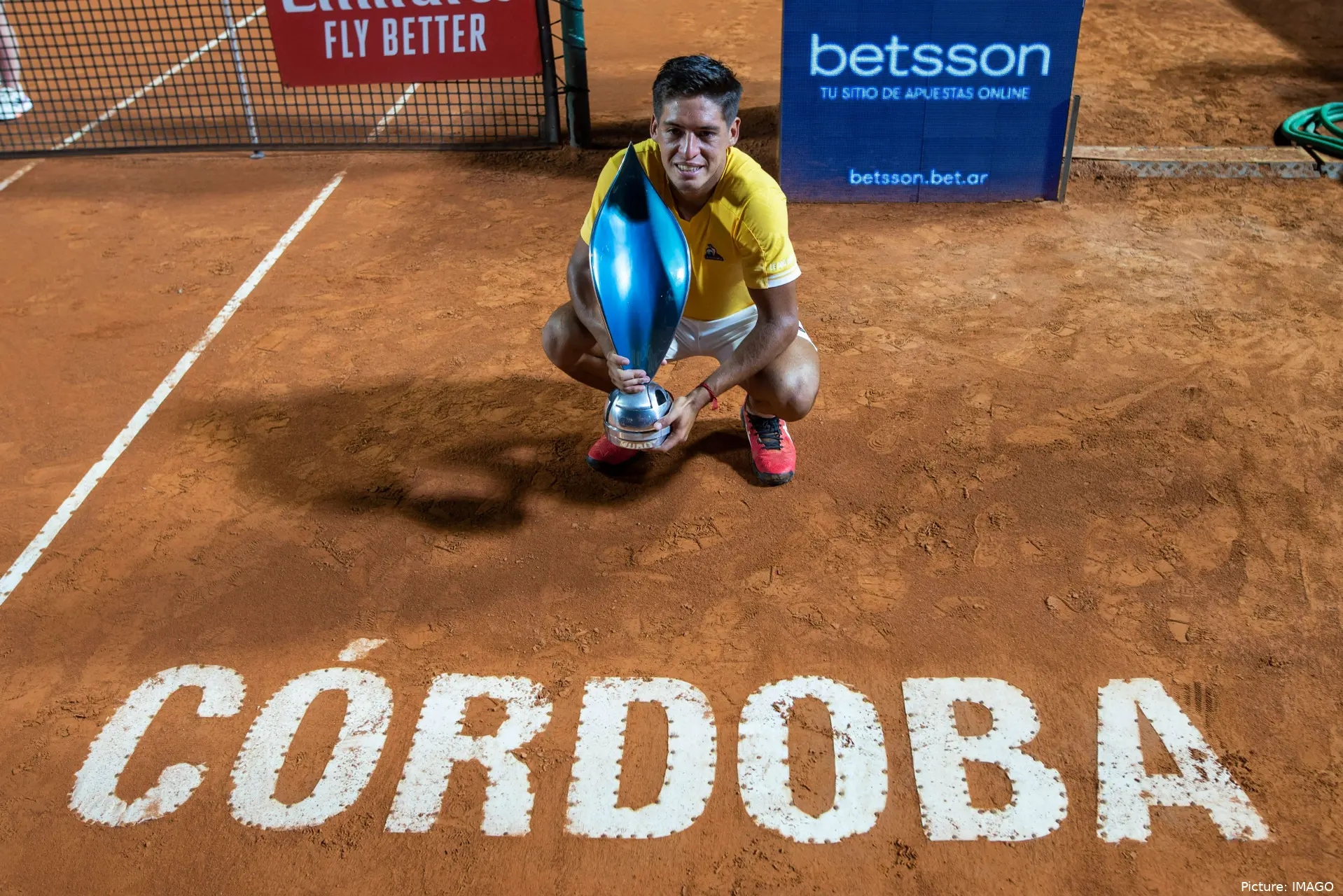 Sebastian Baez holding trophy.